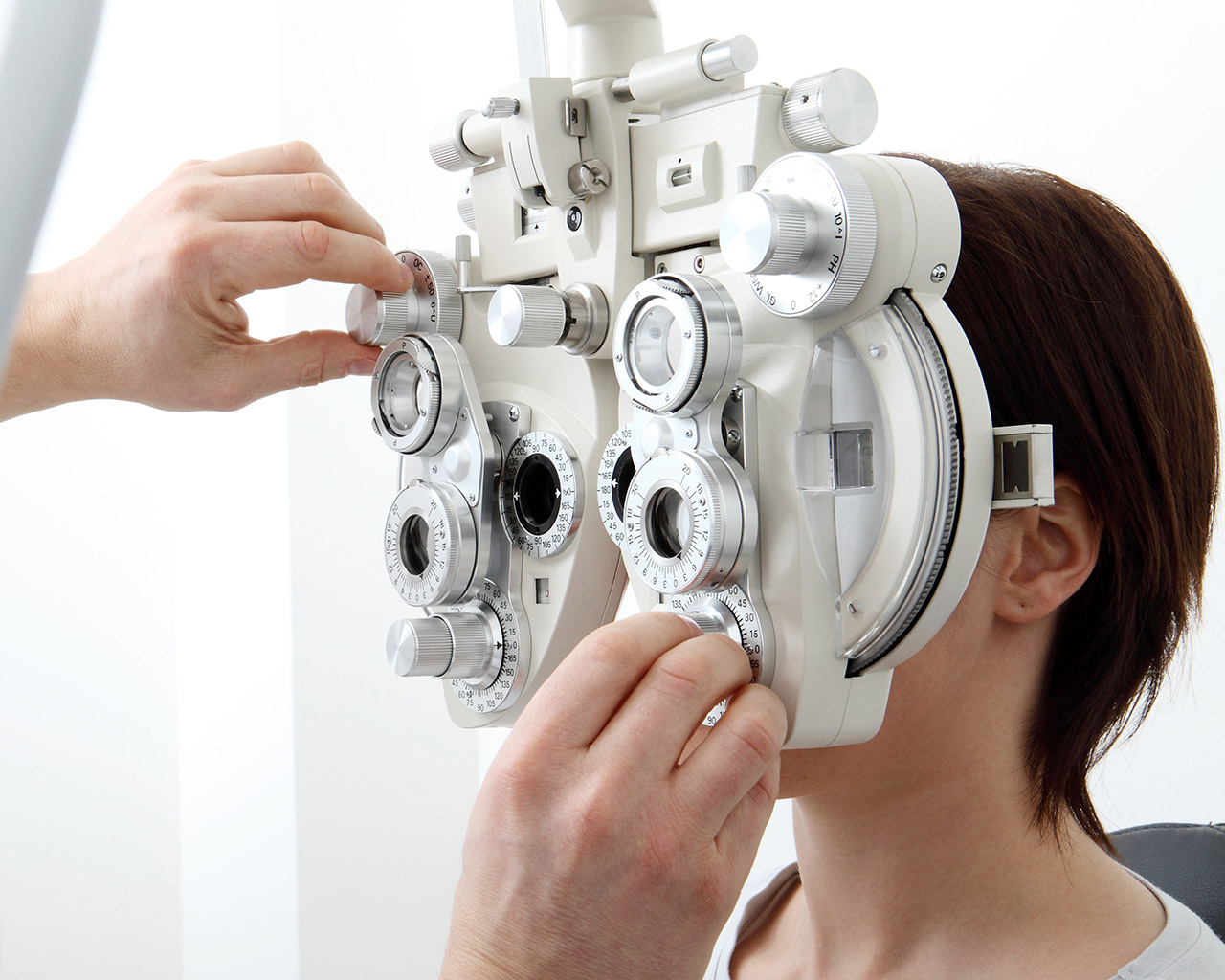Eye doctor performing a vision test using an optometry examination device