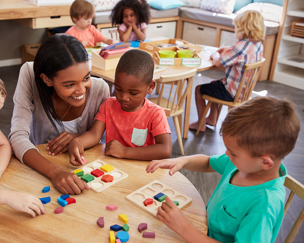 Children participating in a classroom activity with a teacher.
