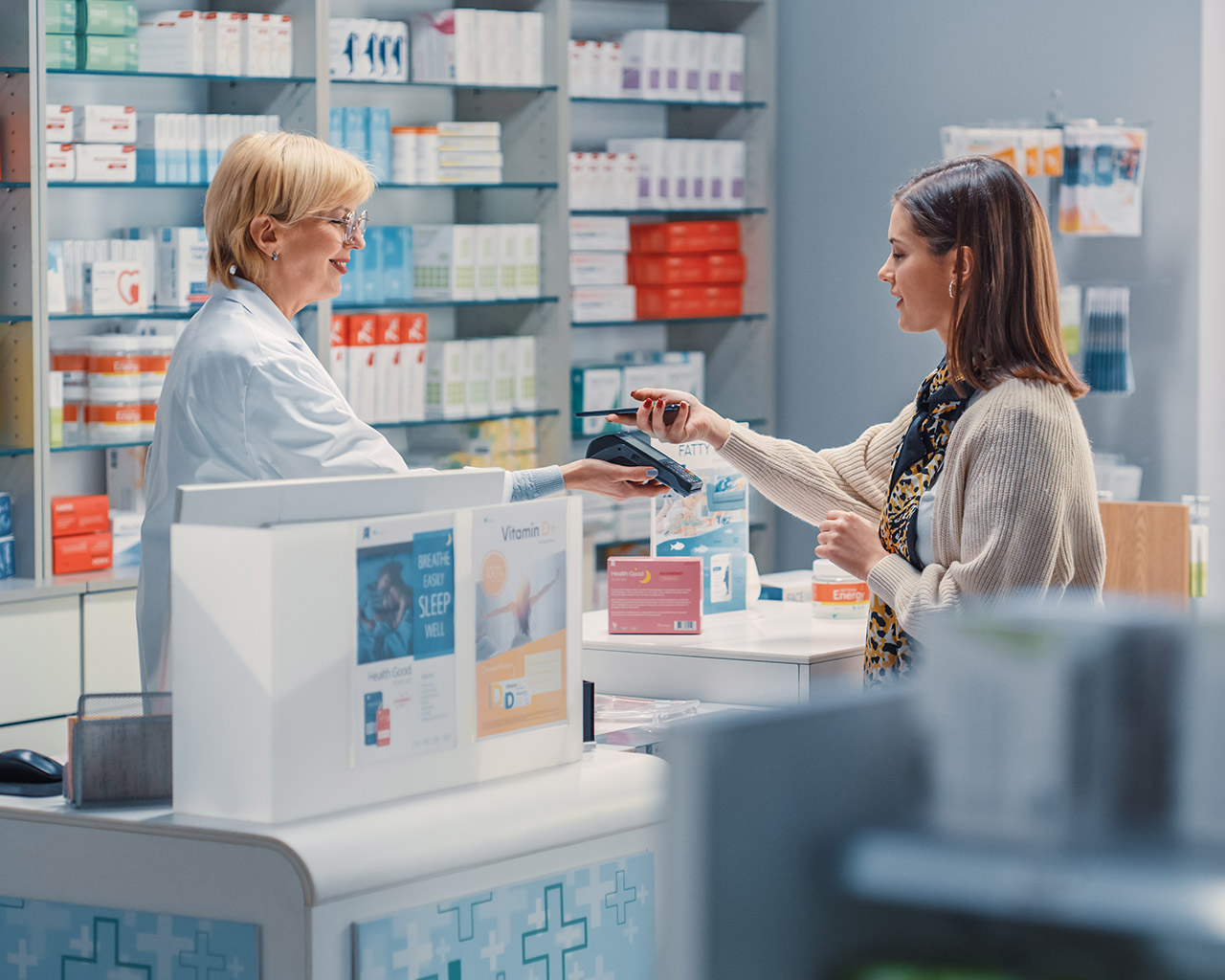 Pharmacist helping a customer understand prescription medication options.