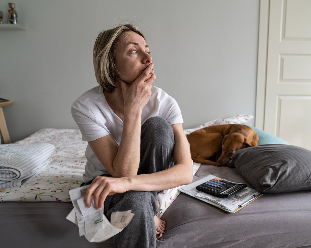 Person reviewing medical bills and insurance documents at home.