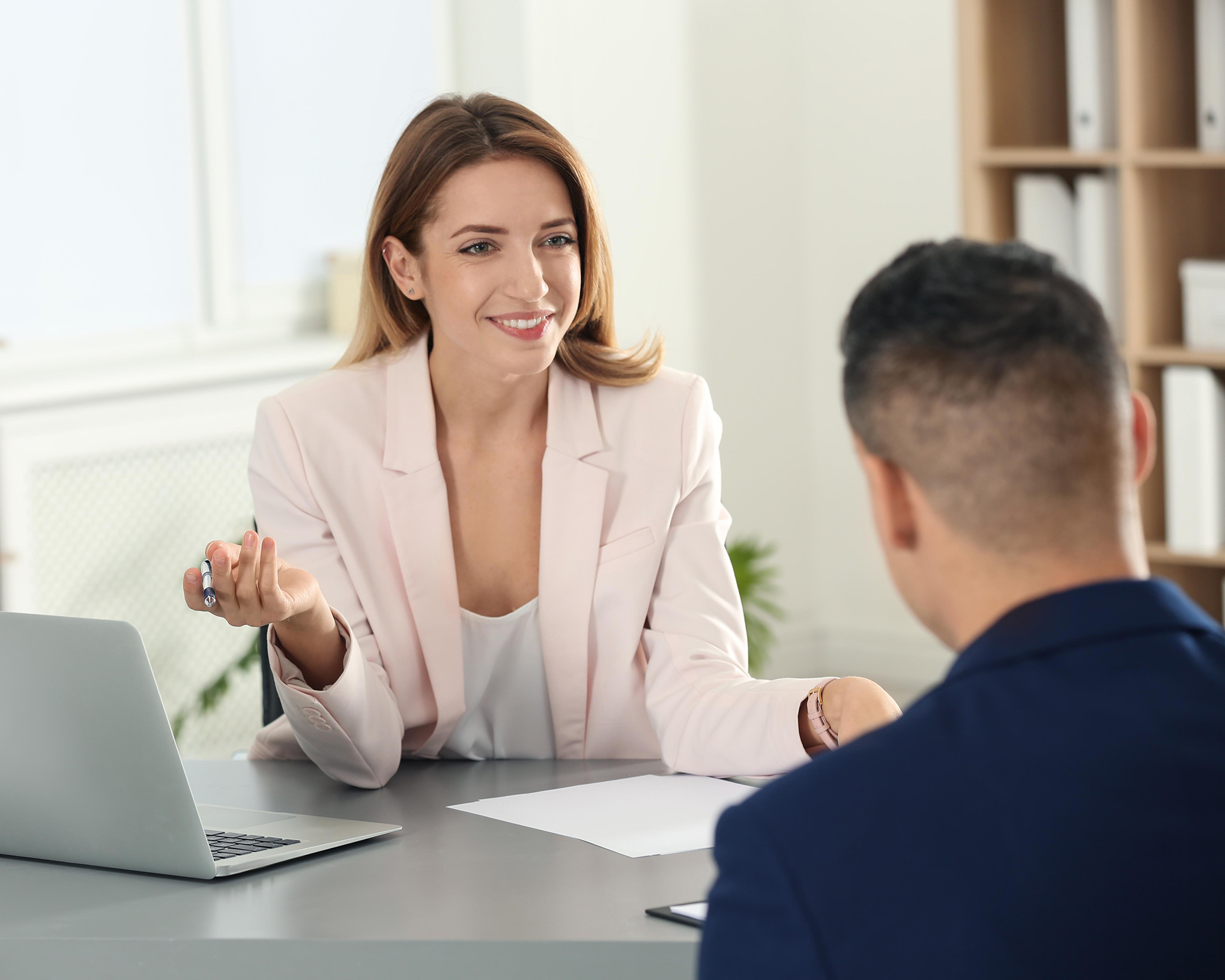 Employee benefits broker discussing workplace coverage options with a client.